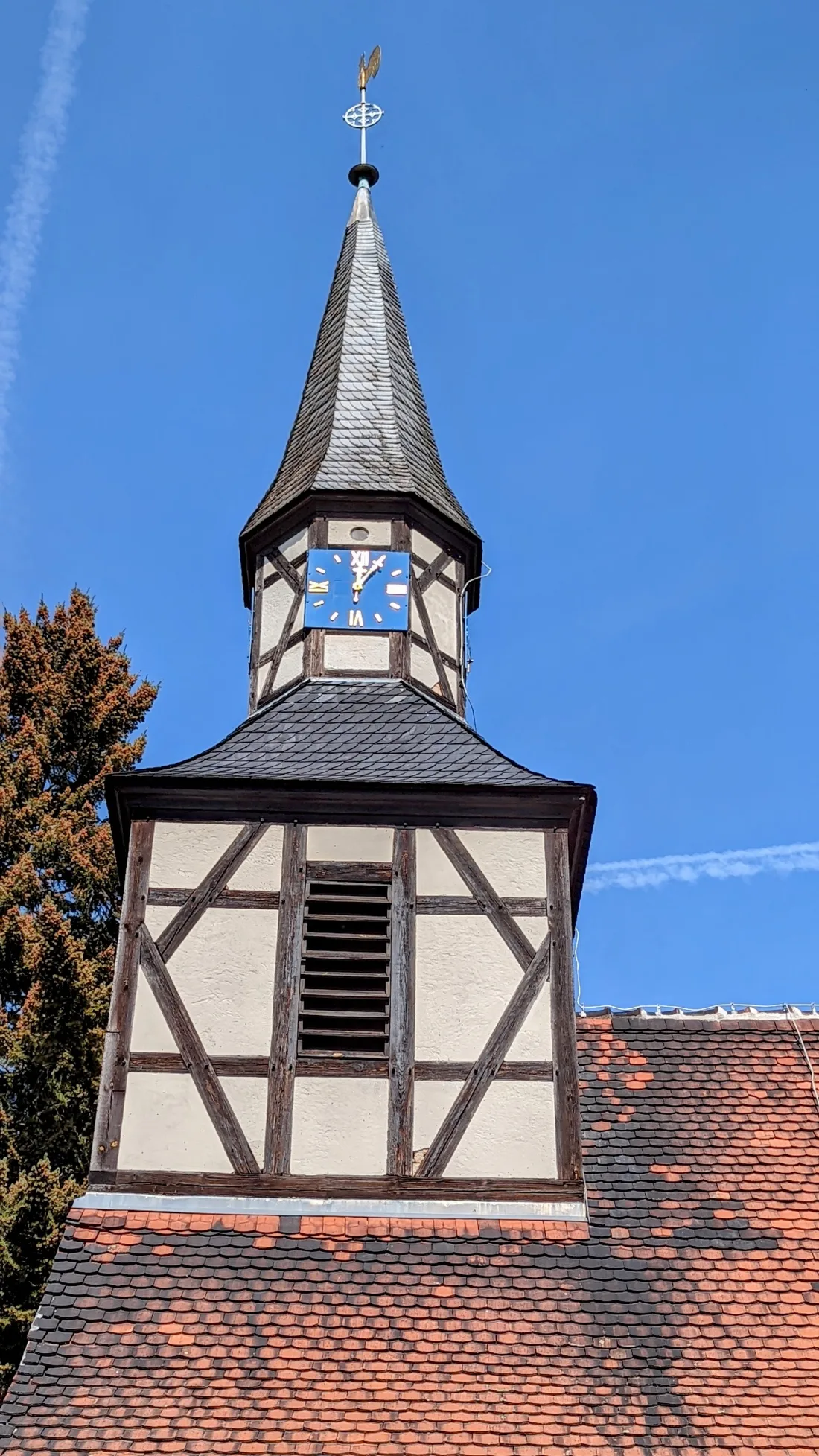 Fachwerkkirche mit Dachreiter und blauer Uhr bei Ragösen
