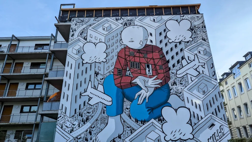Fassade des Neubaus am Wallgraben in Hamburg-Harburg mit dem Wandbild Welcome von Millo