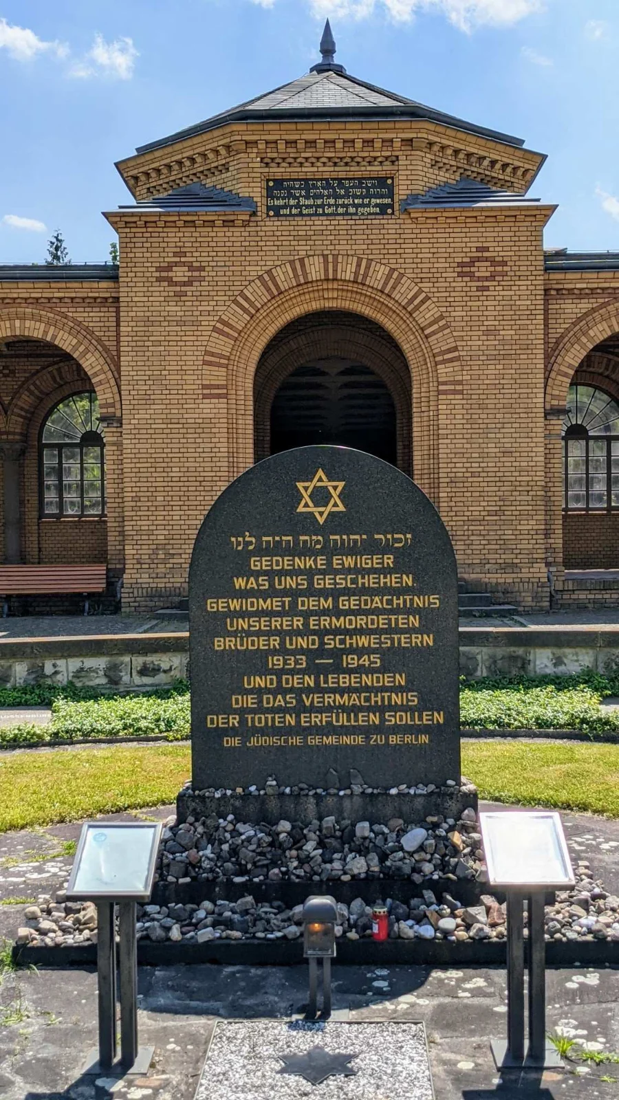 Gedenkstein der Jüdischen Gemeinde im Rondell am Eingang des Jüdischen Friedhofs Weißensee, dahinter der Arkadengang