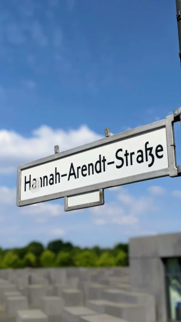 Betonstelen des Denkmals für die ermordeten Juden Europas, dahinter Bäume und Hochhäuser am Potsdamer Platz
