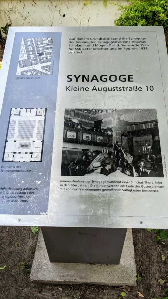 Verkratzte Metalltafel mit Lageplan, Text und historischem Innenraumfoto am Gedenkort der Synagoge Kleine Auguststraße 10