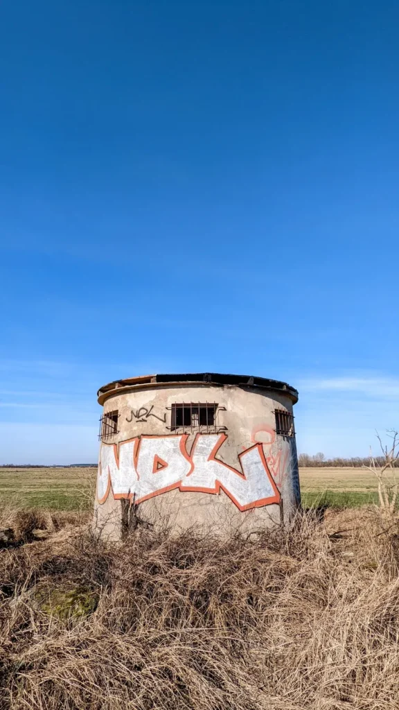 Kleiner runder Bau mit Graffiti und Fensteröffnung