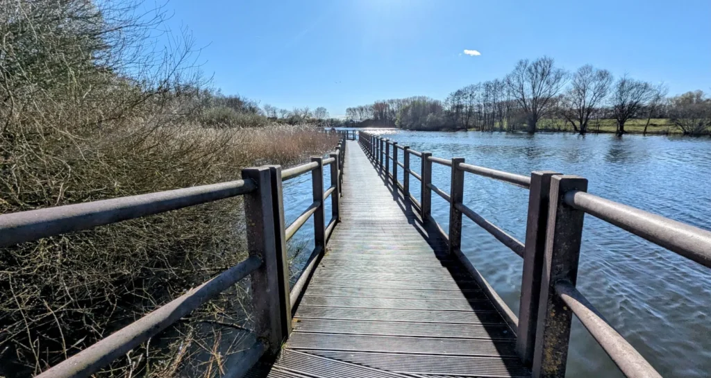 Holzsteg mit Geländer über den Mühlensee bei Vehlefanz