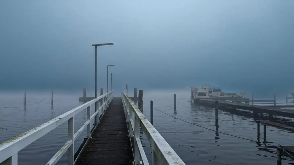 Holzsteg am Wasser in Schmöckwitz, das gegenüberliegende Ufer verschwindet im Februarnebel