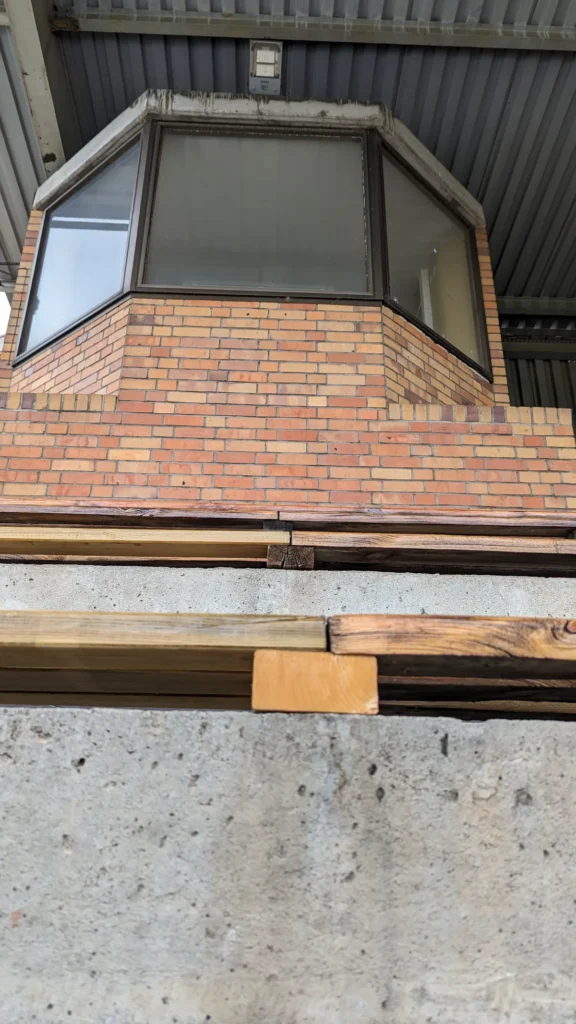 Verglaste Kabine auf einem Backsteinsockel unter dem Tribünendach im Stadion am Quenz