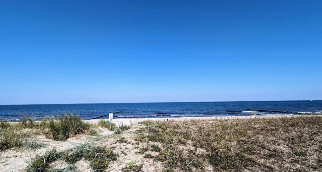 Niedrige Dünen mit Strandhafer am Strand von Ückeritz, dahinter die Ostsee