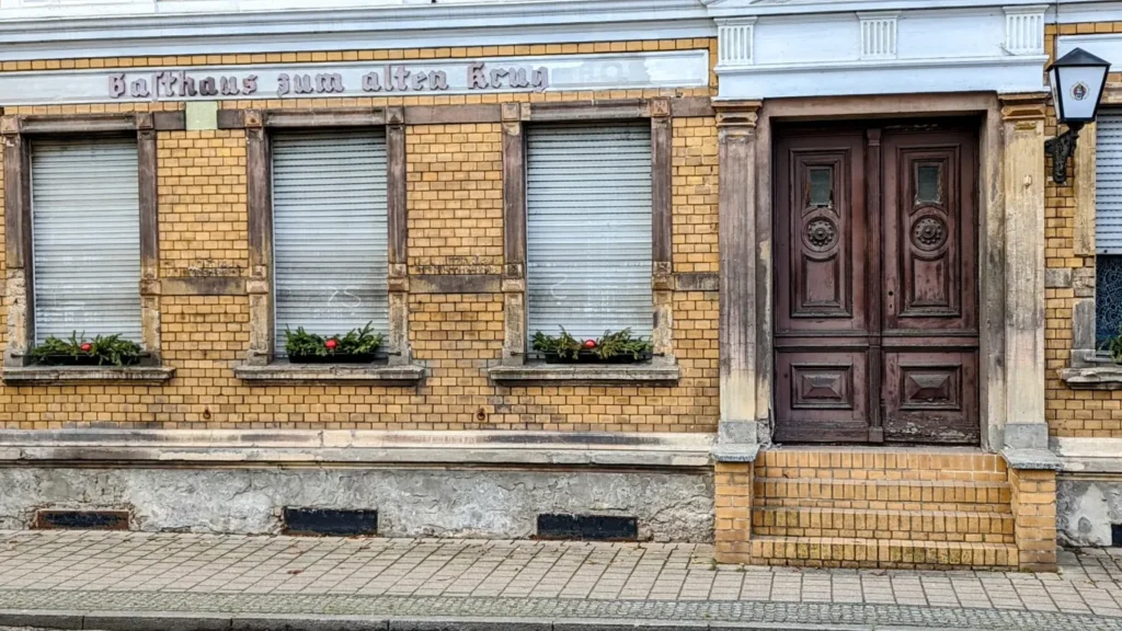 Fassade des Gasthauses Zum alten Krug in Sperenberg mit Holztür